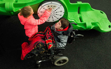 Children playing with ground-level sensory panel