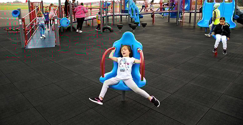 Child playing on inclusive playground Child playing on inclusive playground