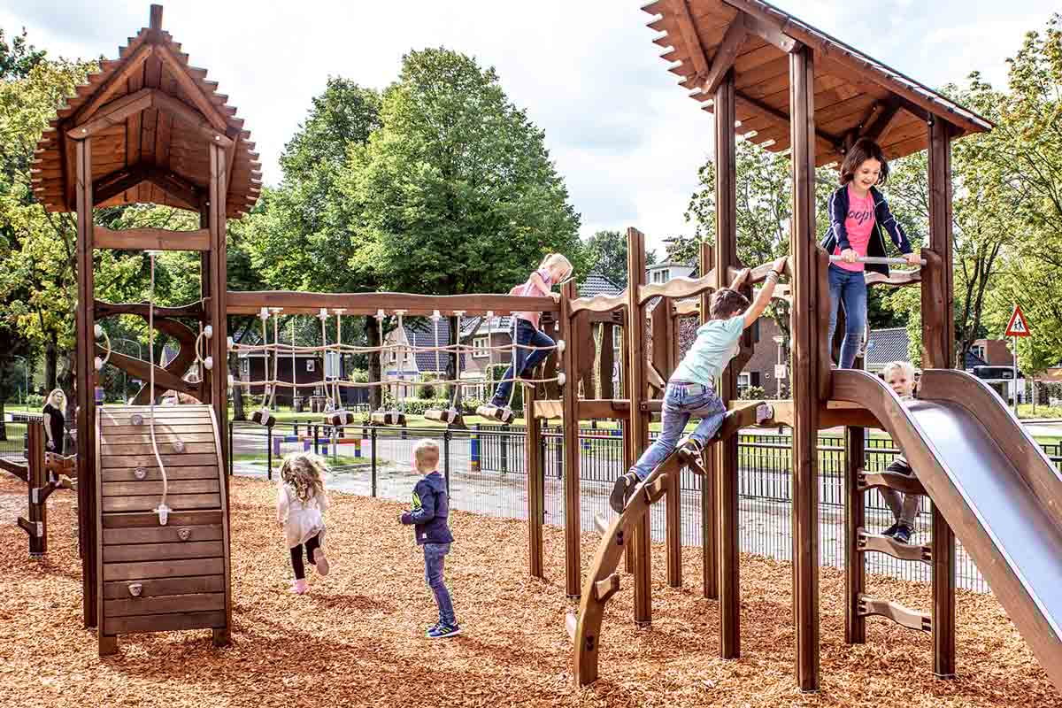 Kids playing on natural Nordic wood playground