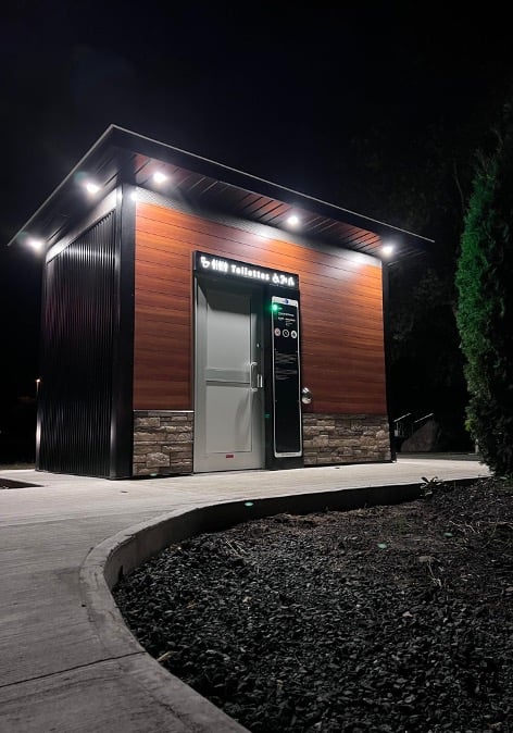 smart public restroom illuminated at night with safety lights